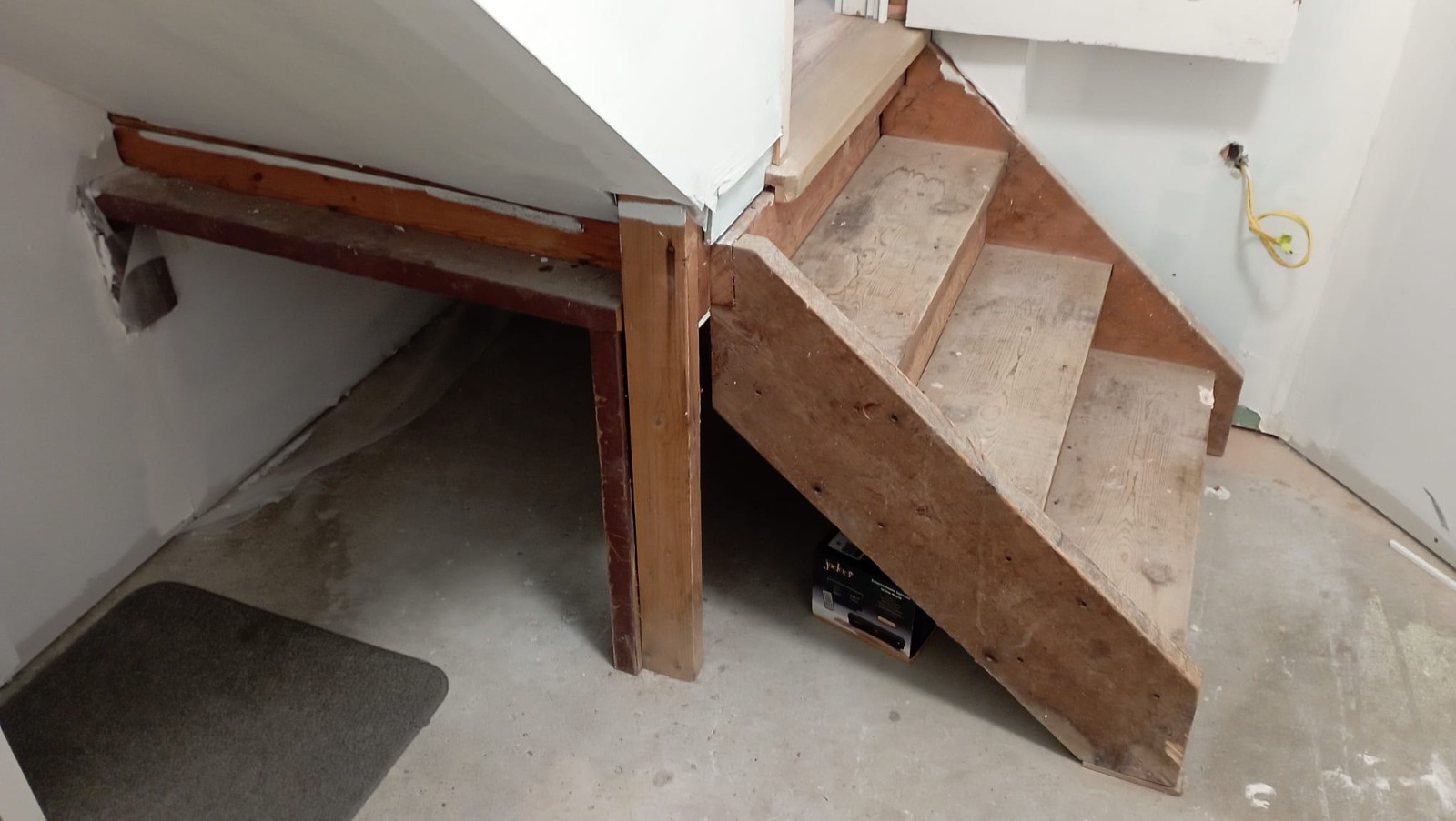 Stringer and tread detail of a basement staircase being rebuilt