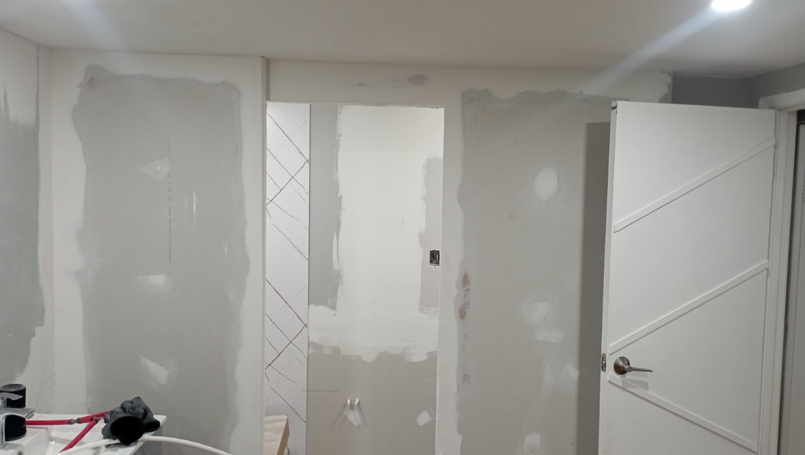 Drywall mudding around bathroom doorway, ready for sanding