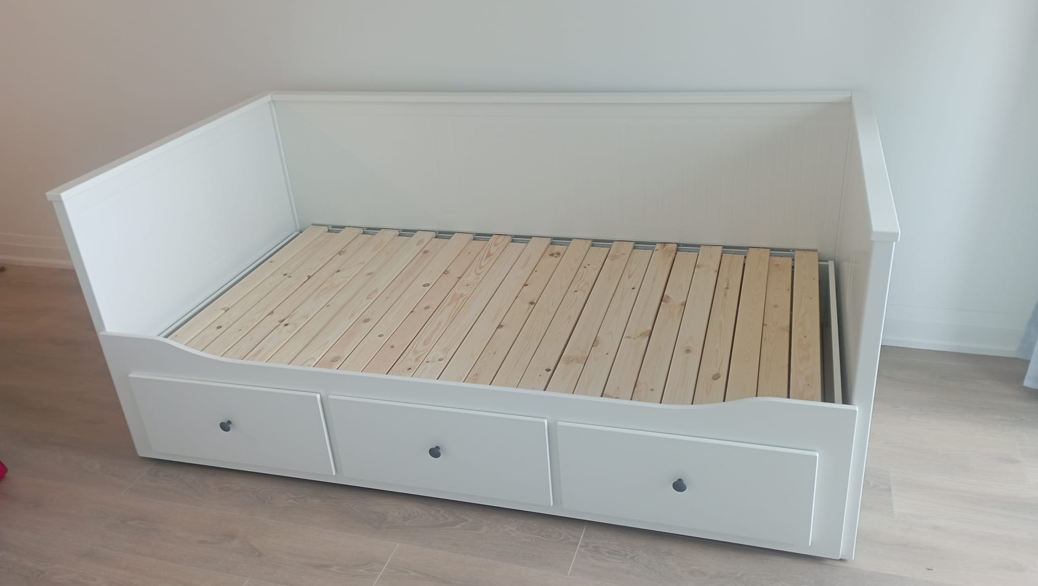 White daybed assembled and squared up in a finished bedroom
