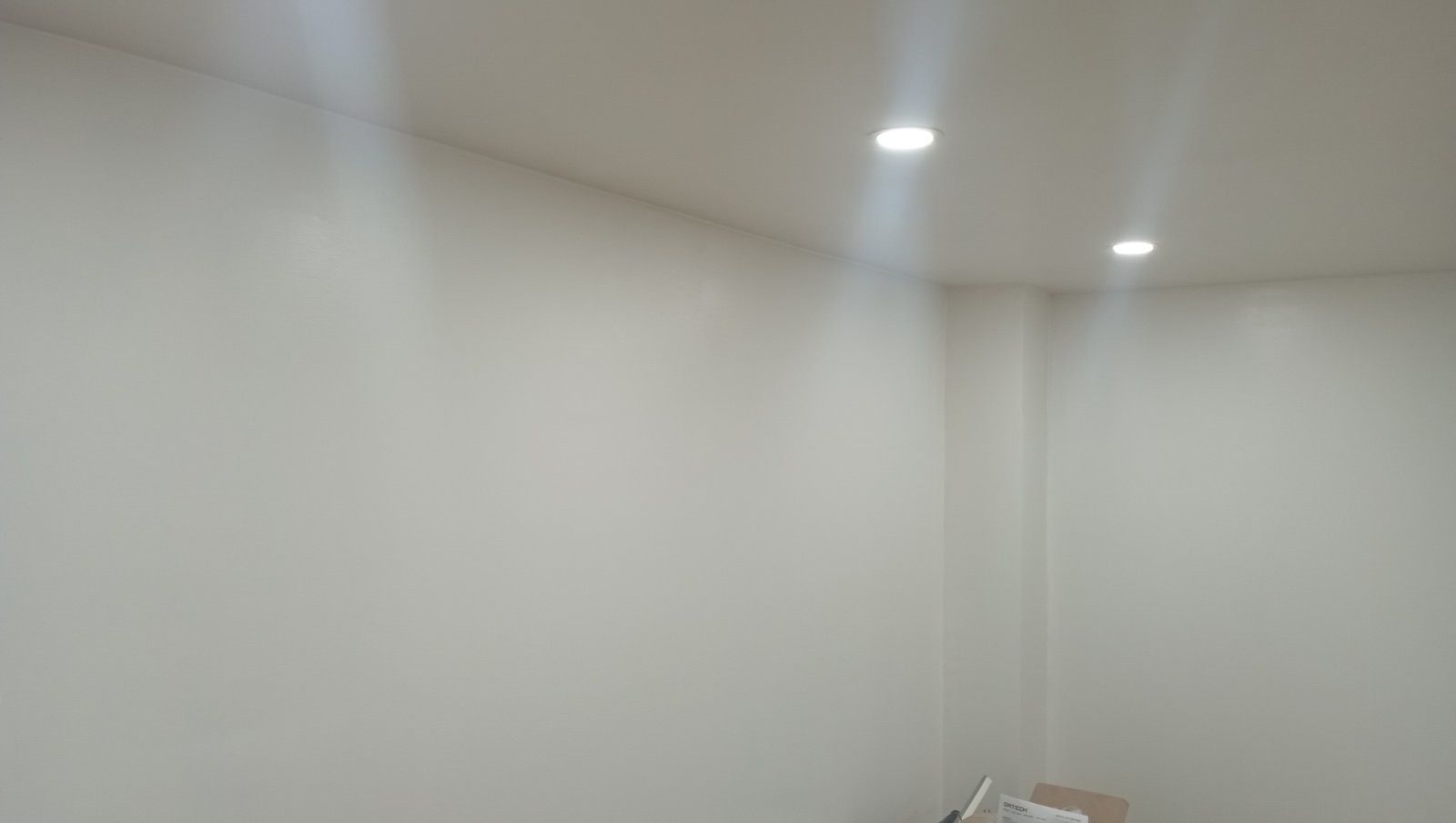 Smooth white ceiling with recessed pot lights after repaint
