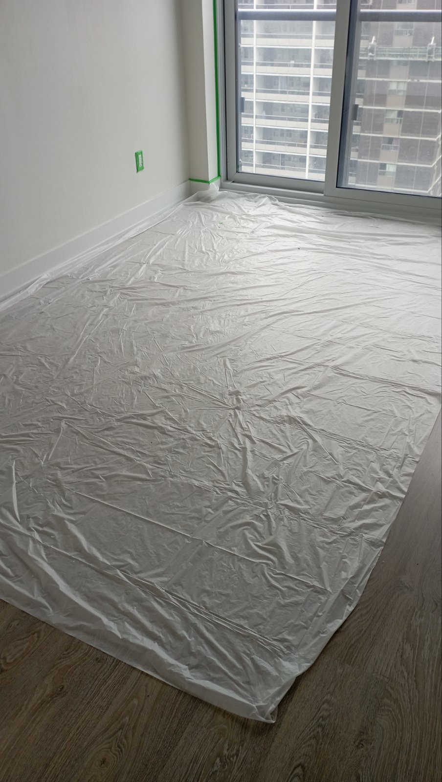 High-rise condo unit prepped with floor protection before painting