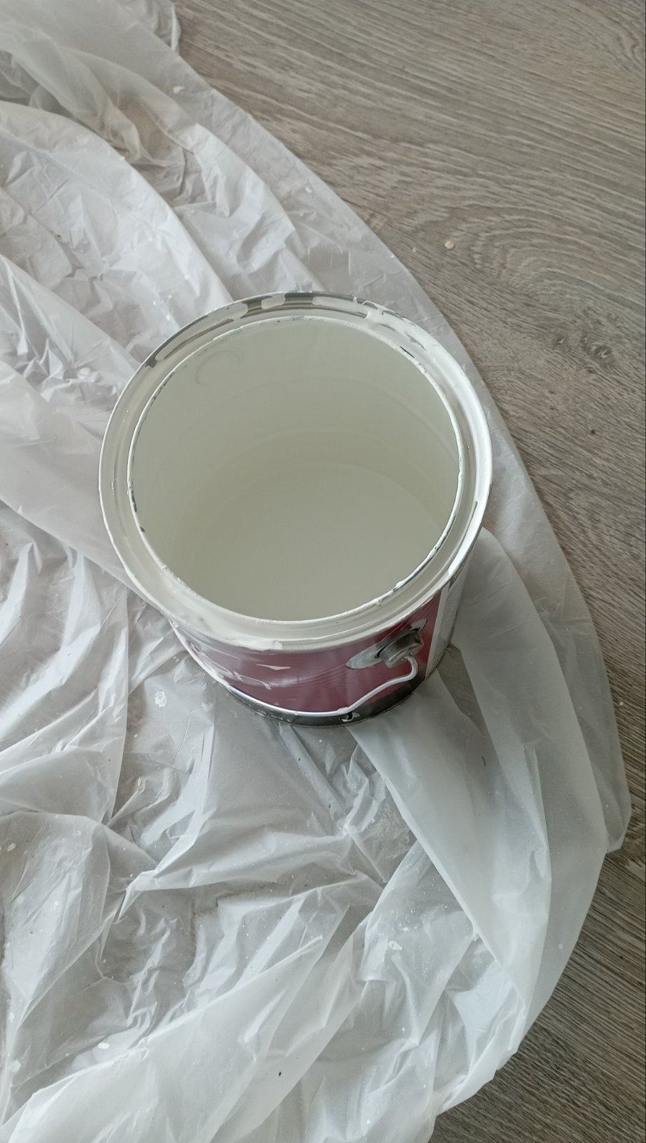 Open paint can on dropcloth ready for the next coat