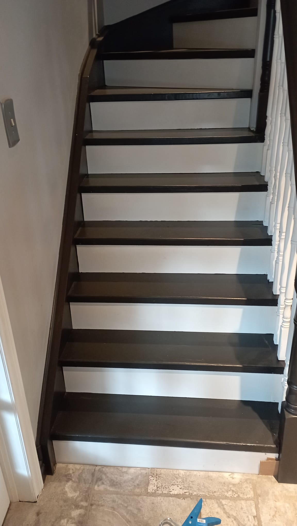 Finished interior staircase with dark treads and crisp white risers