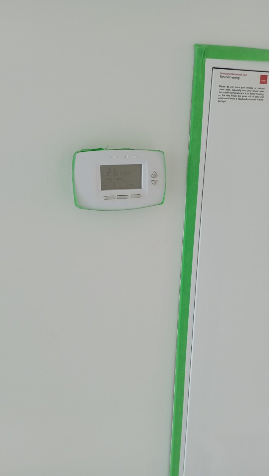 Thermostat carefully masked with green painter's tape before paint