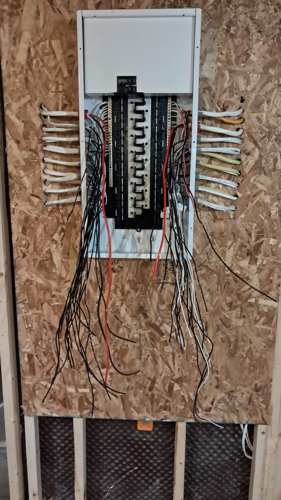 Close-up of electrical panel with circuits landed during rewire