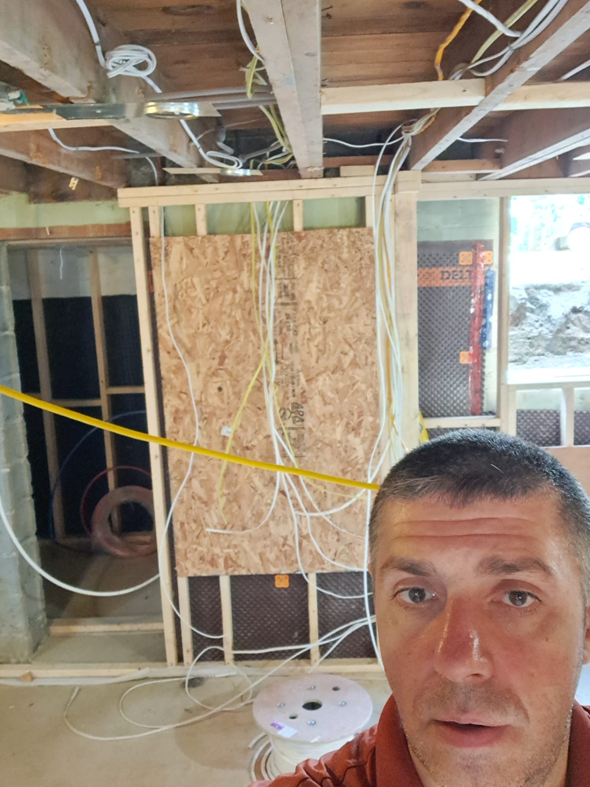 Owner in framed basement with wiring during smart home install